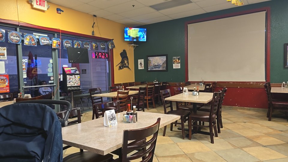 Bar seating beside a restaurant counter.